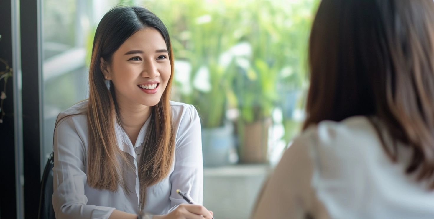 a woman smiling at another woman