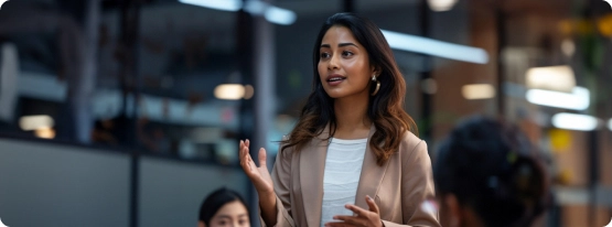 A woman is giving a presentation to a group of people.