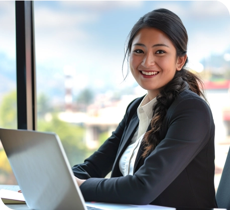 a woman sitting at a desk with a laptop