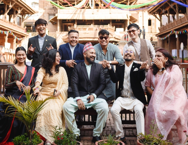 A joyful group in traditional clothing, laughing together.