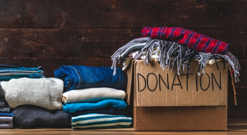 A donation box filled with clothing items, ready to be given to those in need